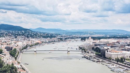 High angle view of river amidst buildings against sky