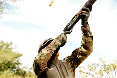 Low angle view of hunter hunting against sky