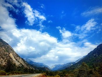 Scenic view of mountains against blue sky