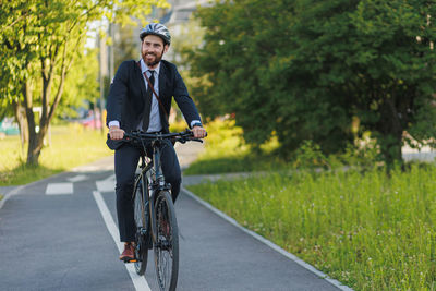 Young man riding bicycle on field