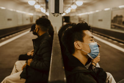 Rear view of people on train at railroad station