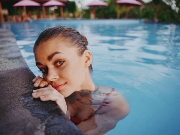 Portrait of young woman in swimming pool