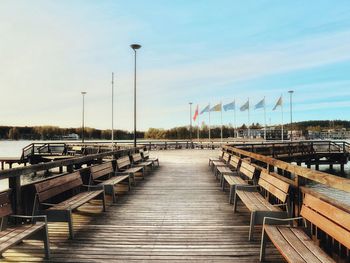 Wooden posts in row against sky