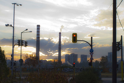 Street lights against sky during sunset