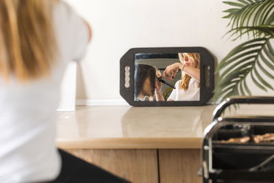 Side view of woman using mobile phone