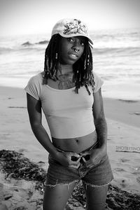 Young woman standing at beach