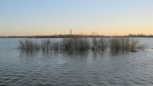 Scenic view of lake against clear sky during winter