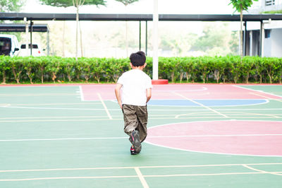 Boy running at basketball court