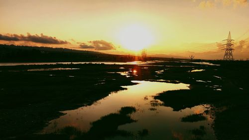 Scenic view of lake against sky during sunset