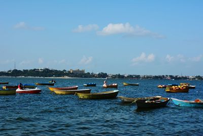 Boats moored on sea against sky