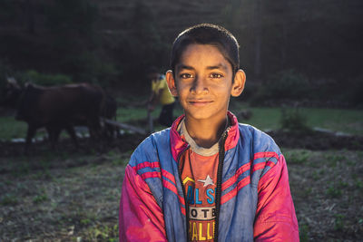 Portrait of smiling boy standing outdoors