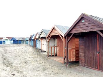 Beach huts against clear sky