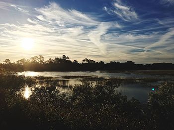 Scenic view of lake against sky during sunset