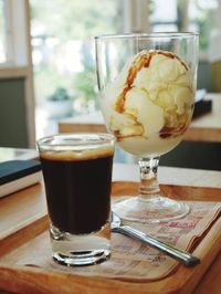 Glass of ice cream on table