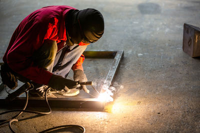 Workers are welding a steel frame.