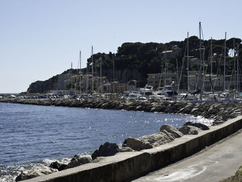 Sailboats on sea against clear sky