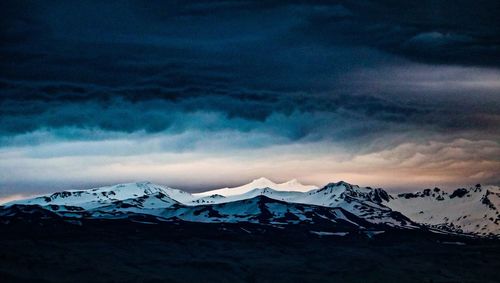 Scenic view of snowcapped mountains against sky during winter