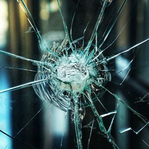 Close-up of spider web on glass window