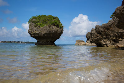 Scenic view of rocks in sea against sky