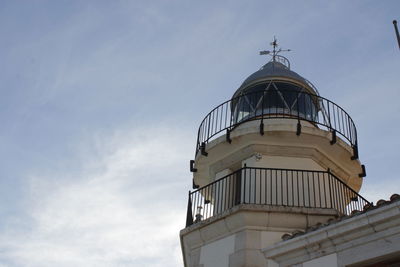 Low angle view of lighthouse on building against sky