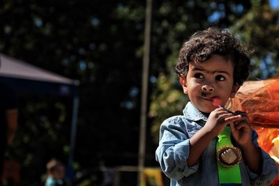 Portrait of boy holding outdoors