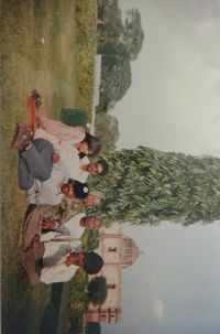 People by tree against sky