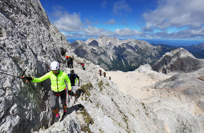 High angle view of hikers hiking on rocky mountain