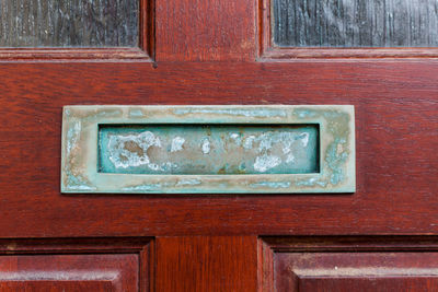 Close-up of weathered door on wall