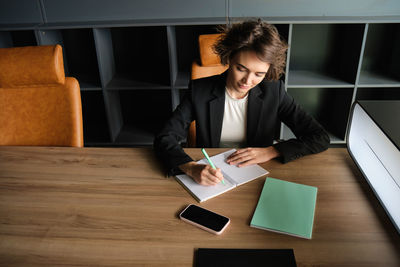 Side view of business colleagues working in office