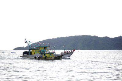 Boat in sea against clear sky