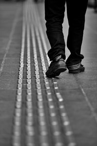 Low section of man walking on footpath