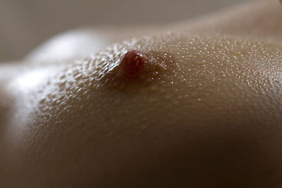 Close-up of water drops on woman breast