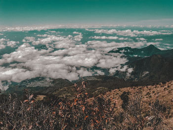 Aerial view of land and mountains against sky