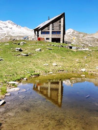 Scenic view of lake by building against sky