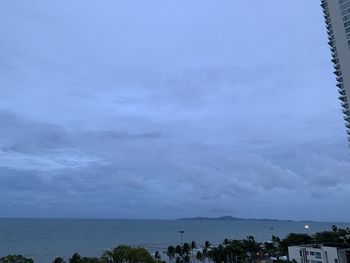 Scenic view of sea by buildings against sky