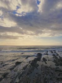 Scenic view of beach against sky during sunset