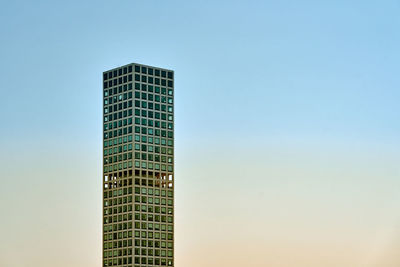 Low angle view of skyscraper against clear sky