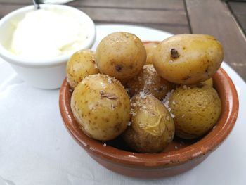 Papas arrugadas spanish tapas salty potatoes with aioli sauce in pot