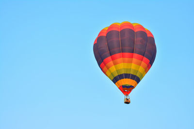 Low angle view of hot air balloon against blue sky