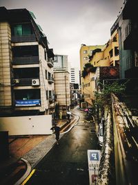 Street amidst buildings against sky in city