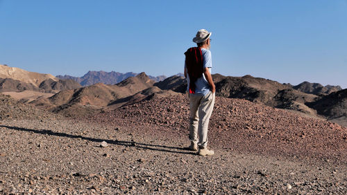 Rear view of senior man standing on mountain