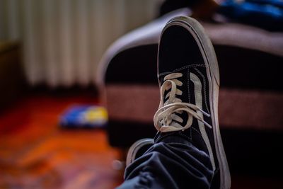 Low section of person wearing canvas shoes