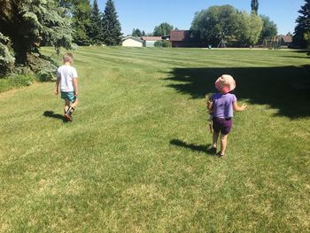 Full length of children on field