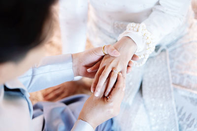 Midsection of couple holding hands