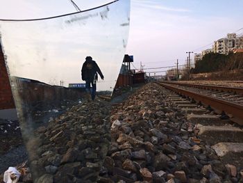 Woman standing on railroad track