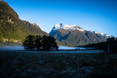 Scenic view of silhouette mountains against sky during winter