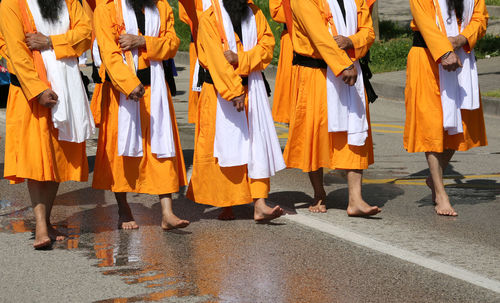 Low section of people standing on street