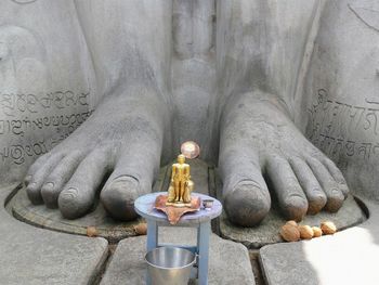 Close-up of buddha statue against temple