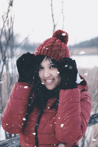 Portrait of smiling woman in snow