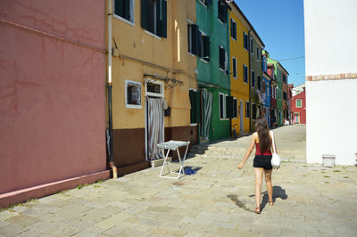 Woman with umbrella walking on street